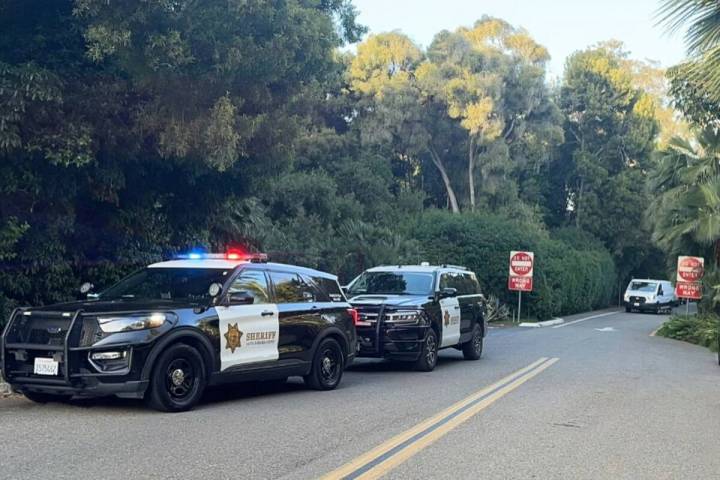 This photograph shows police activity outside of a home after a break-in, Wednesday, May 21, 20 ...