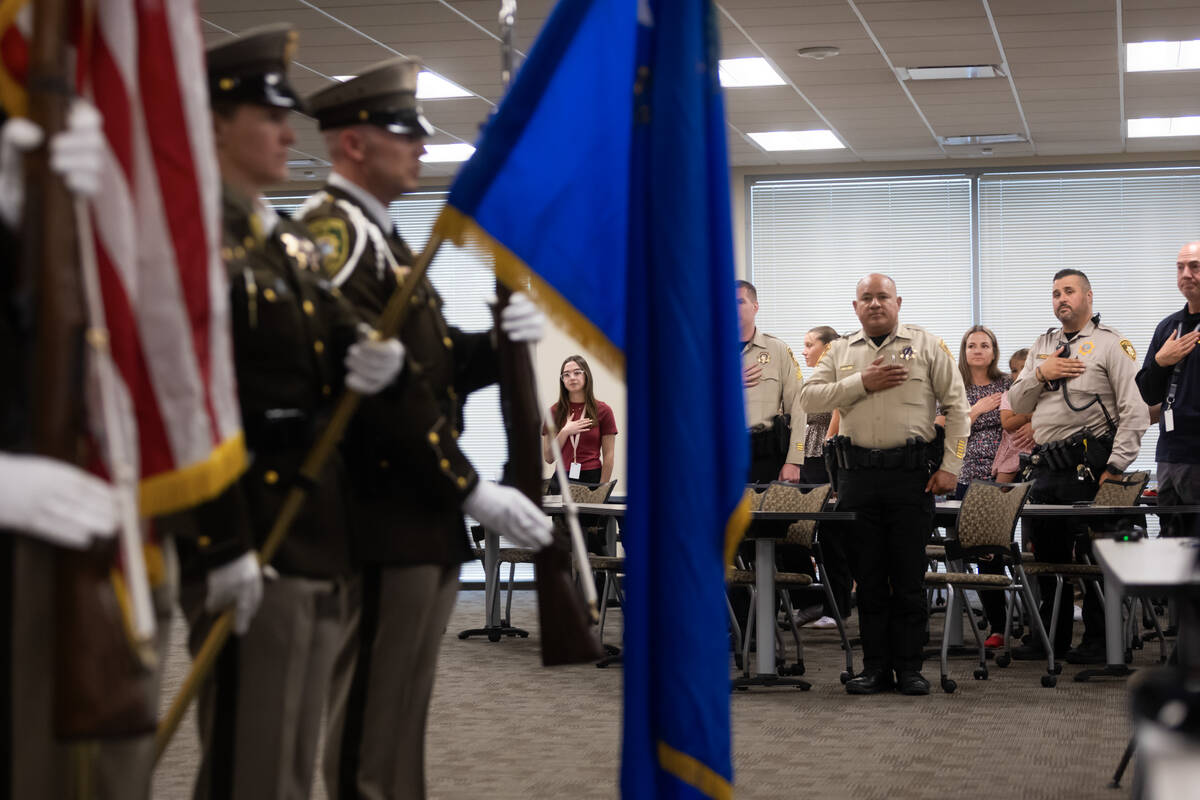 Las Vegas police officers stand for the Pledge of Allegiance during a commendations ceremony he ...