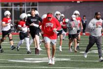 UNLV football head coach Dan Mullen and his players take the field during team practice, on Thu ...