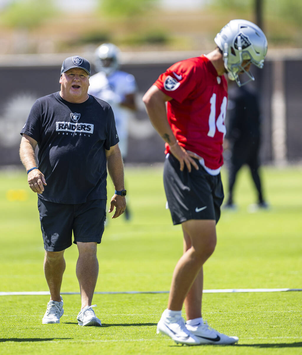 Raiders offensive coordinator Chip Kelly communicates his message to quarterback Carter Bradley ...