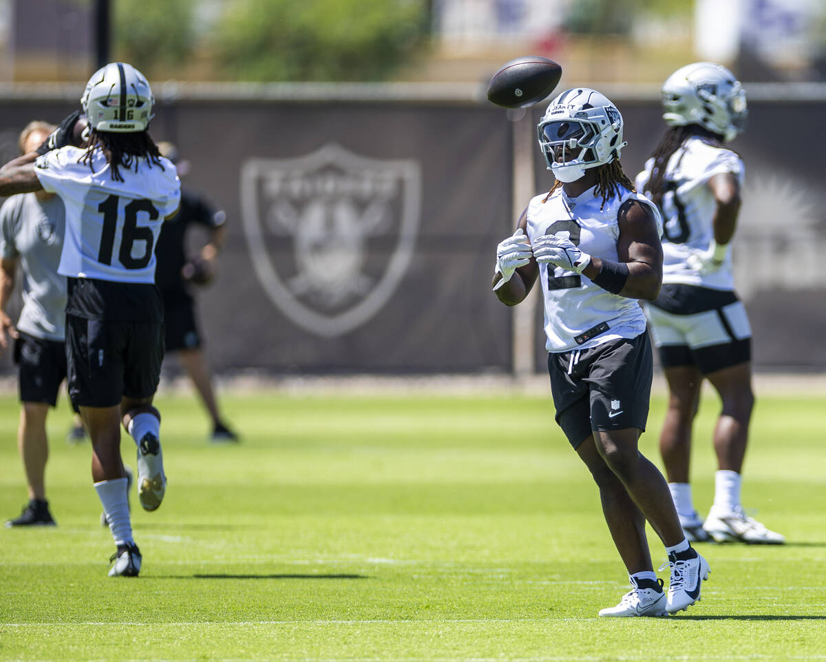 Raiders running back Ashton Jeanty (2) tosses a ball after running a drill during OTA's at the ...