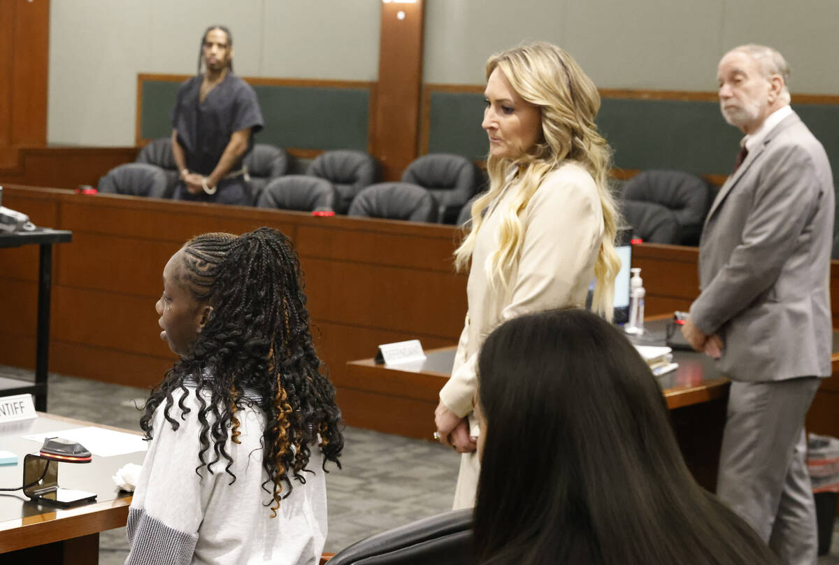 Charlveena Veecee, left seated, the mother of a 5-year-old boy who was killed by his father, de ...