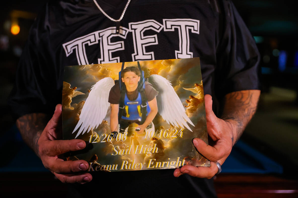 Thomas John Enright III holds a photograph of his son, Keanu, who was shot and killed at the ag ...
