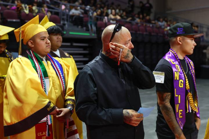Keanu Enright’s father, Thomas Enright, center, wipes tears away as he, Keanu’s b ...