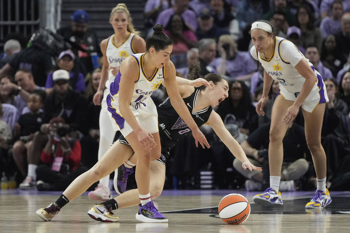 Los Angeles Sparks guard Kelsey Plum, foreground left, fouls Golden State Valkyries guard Carla ...