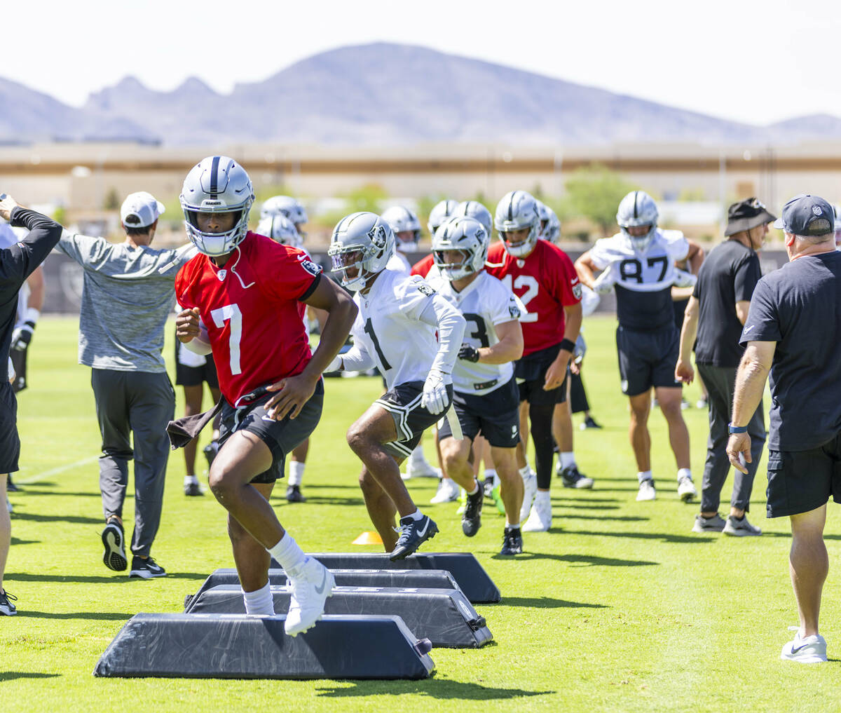 Raiders quarterback Geno Smith (7) runs a drill with teammates during Raiders OTA's at the Inte ...