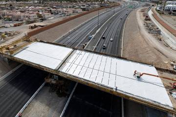 Crews pour concrete on the new Peace Way Bridge over the 215 Beltway, on Saturday, March 1, 202 ...