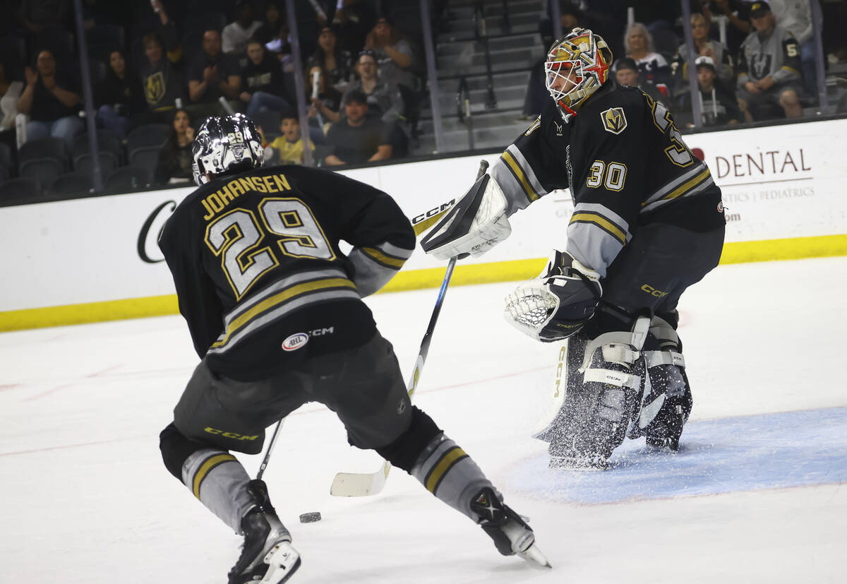 Silver Knights goaltender Carl Lindbom (30) passes the puck to defenseman Lucas Johansen (29) d ...