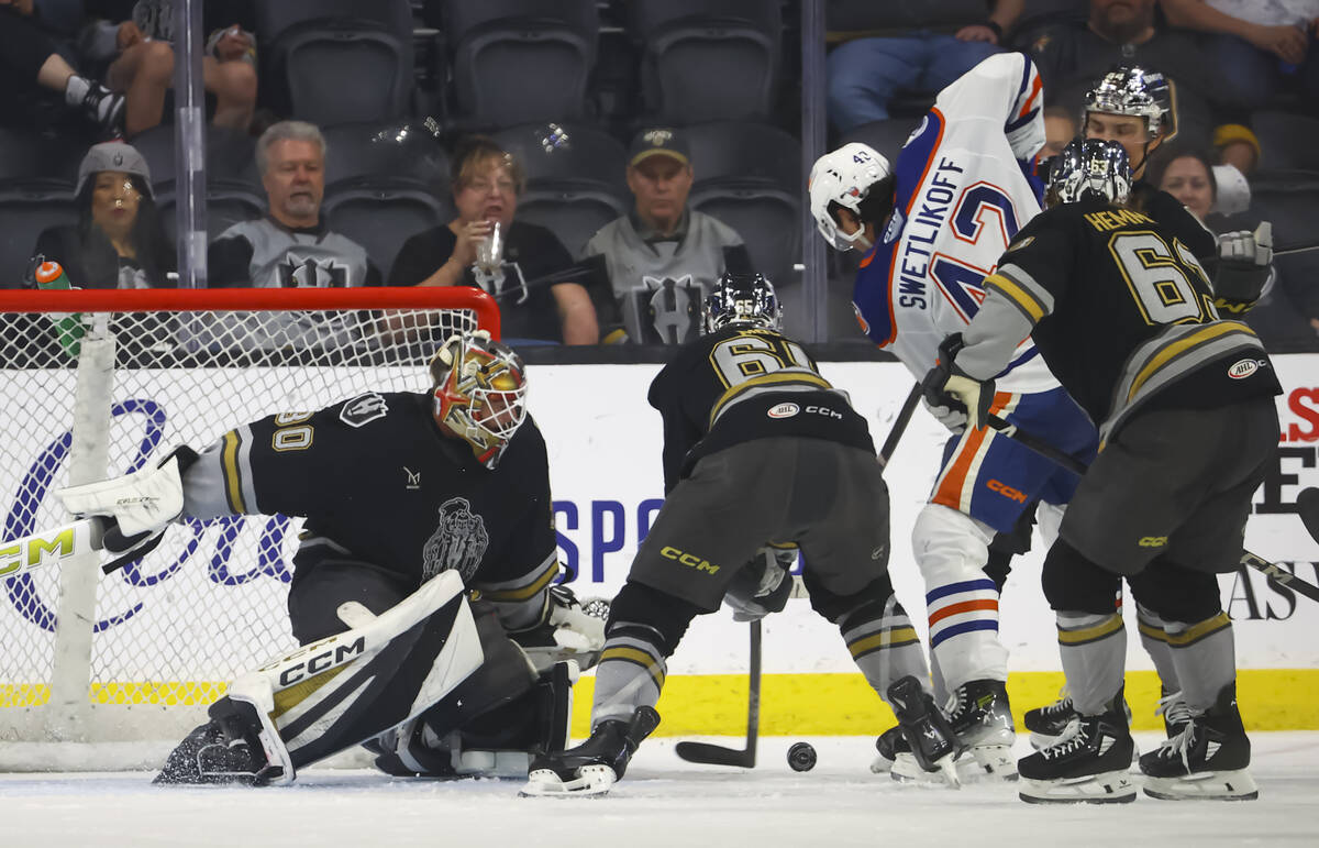 Silver Knights goaltender Carl Lindbom (30) and defenseman Dysin Mayo (65) defend the net durin ...