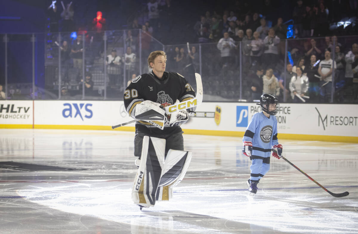 Silver Knights goaltender Carl Lindbom (30) skates to the net following introductions before an ...