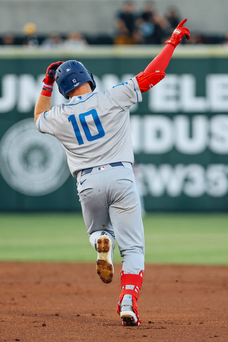 Oklahoma City Dodgers outfielder Ryan Ward (10) signals as he runs the bases for a home run dur ...
