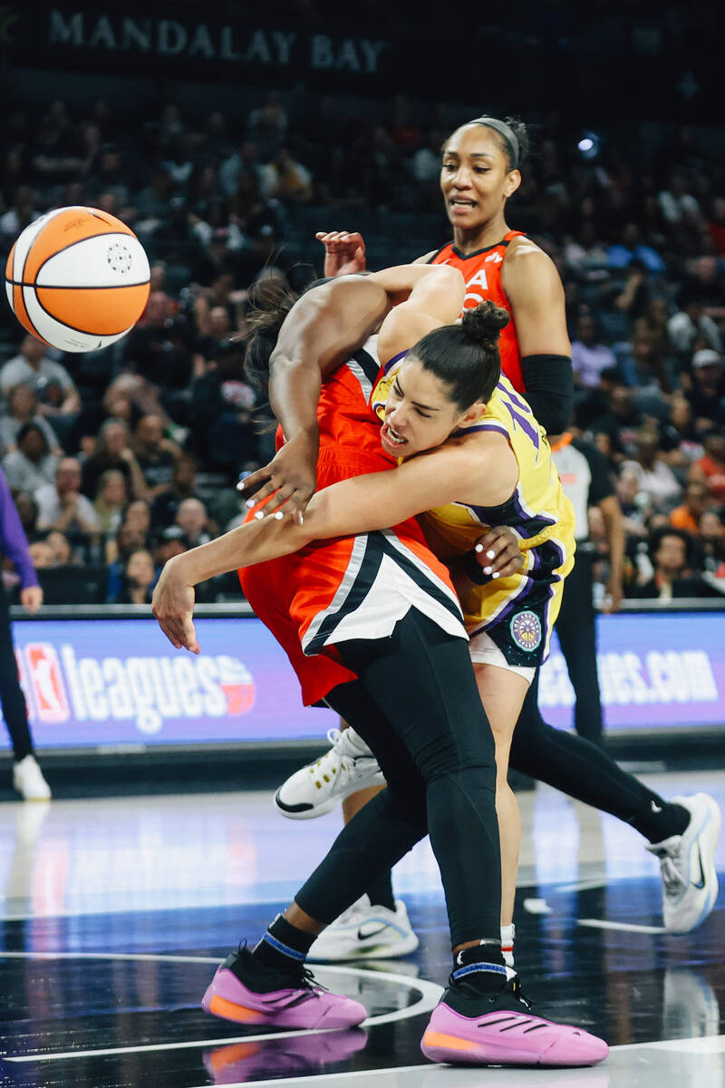 Los Angeles Sparks guard Kelsey Plum (10) fails to reach the ball over Aces guard Chelsea Gray ...