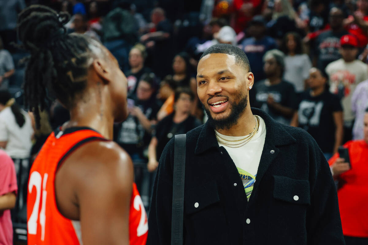 Aces guard Jewell Loyd, left, greets Milwaukee Bucks star Dame Lillard following a WNBA basketb ...