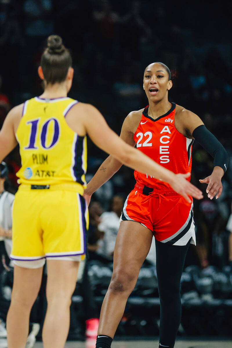 Aces center A'ja Wilson (22) greets Los Angeles Sparks guard Kelsey Plum (10) during a WNBA bas ...