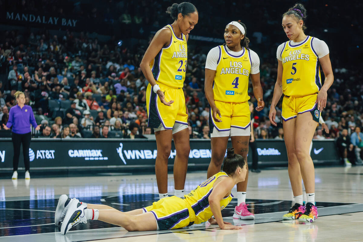 Los Angeles Sparks guard Kelsey Plum (10) gets up after falling during a WNBA basketball game b ...