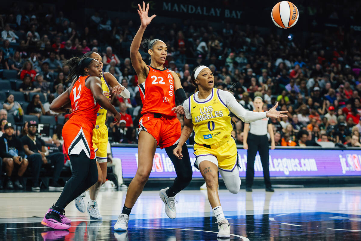 Los Angeles Sparks guard Odyssey Sims (0) runs after the ball as Aces center A'ja Wilson (22) d ...