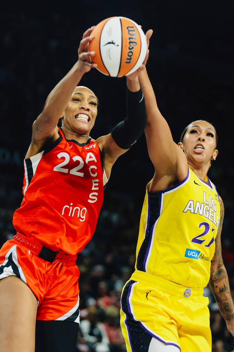 Aces center A'ja Wilson (22) and Los Angeles Sparks center Mercedes Russell (21) struggle over ...