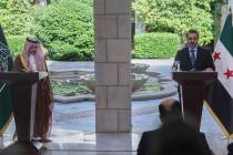 Syrian Foreign Minister Asaad al-Shibani, right, speaks during a joint press conference with hi ...
