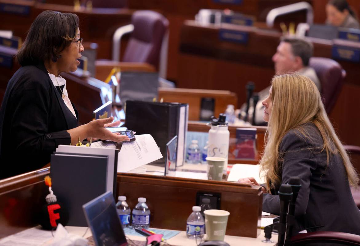 Assembly member Daniele Monroe-Moreno, D-North Las Vegas, left, talks with Venicia Considine, D ...