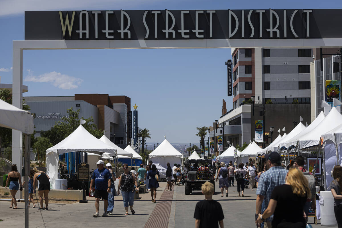 People walk along Water Street during the the Art Festival of Henderson Sunday, May 11, 2025. ( ...