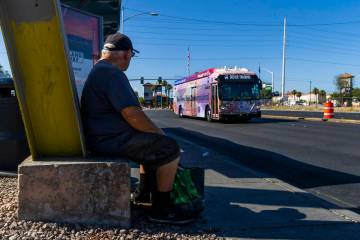 A rider watches a bus moving northbound past a stop along the Maryland Parkway on Aug 3, 2024, ...