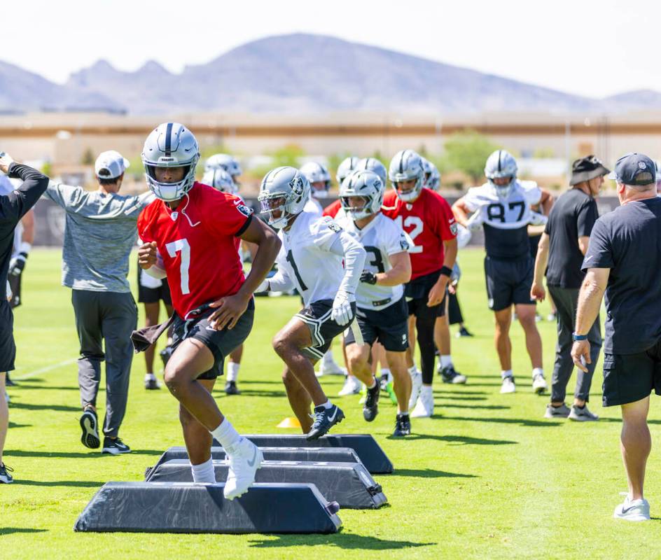 Raiders quarterback Geno Smith (7) runs a drill with teammates during Raiders OTA's at the Inte ...