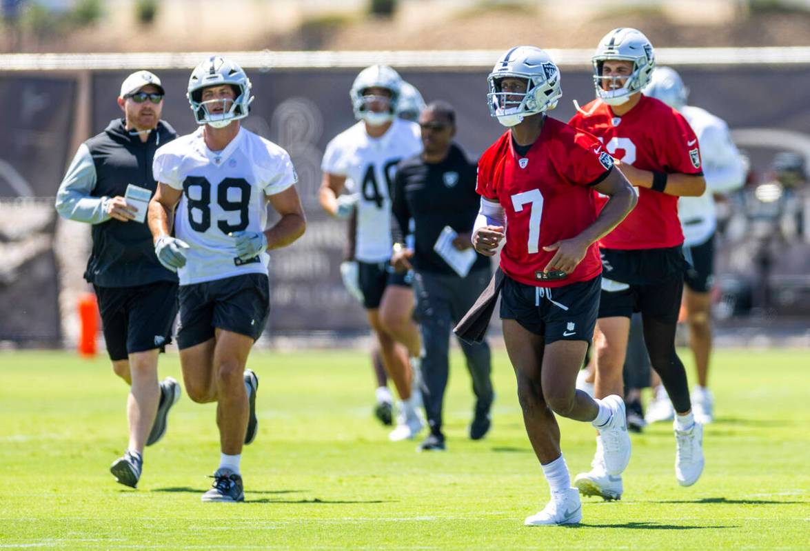 Raiders quarterback Geno Smith (7) and tight end Brock Bowers (89) move to another spot with te ...