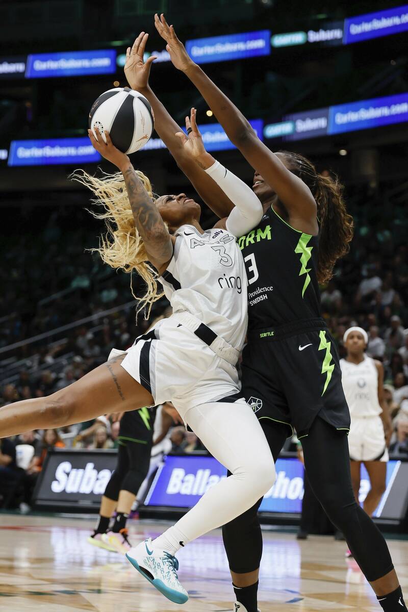 Las Vegas Aces guard Tiffany Mitchell , left, has her shot blocked by Seattle Storm forward Ezi ...