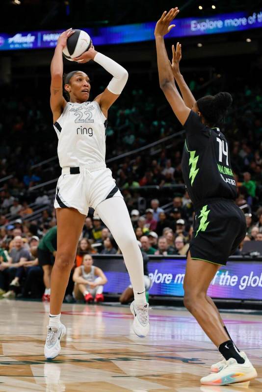 Las Vegas Aces center A'ja Wilson, left, looks to shoot over Seattle Storm center Dominique Mal ...