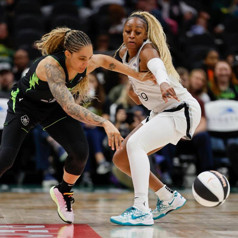 Las Vegas Aces guard Tiffany Mitchell, right, tries to steal the ball from Seattle Storm forwar ...