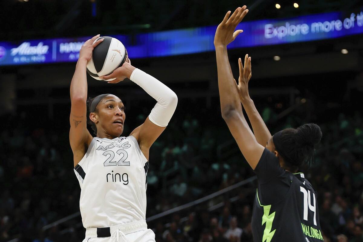 Las Vegas Aces center A'ja Wilson, left, looks to shoot over Seattle Storm center Dominique Mal ...