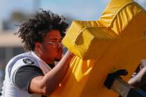 Clark High School offensive lineman Dominic Harris pushes against a drill dummy at practice on ...