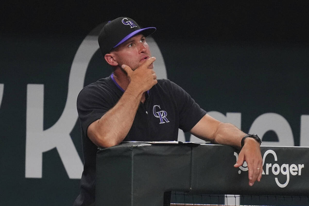 Colorado Rockies interim manager Warren Schaeffer looks out from the dugout during the ninth in ...