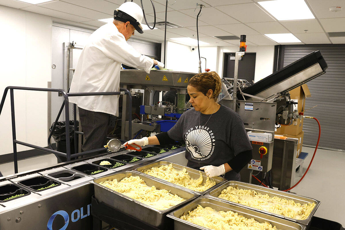 Workers for Meals on Wheels prepare meals for clients at the Catholic Charities of Southern Nev ...