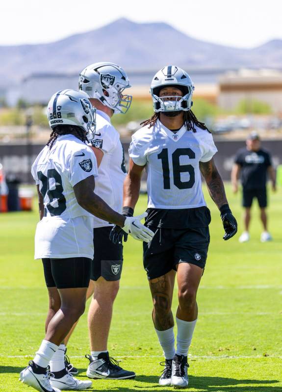 Raiders wide receiver Jakobi Meyers (16) greets running back Sincere McCormick (28) on warm ups ...