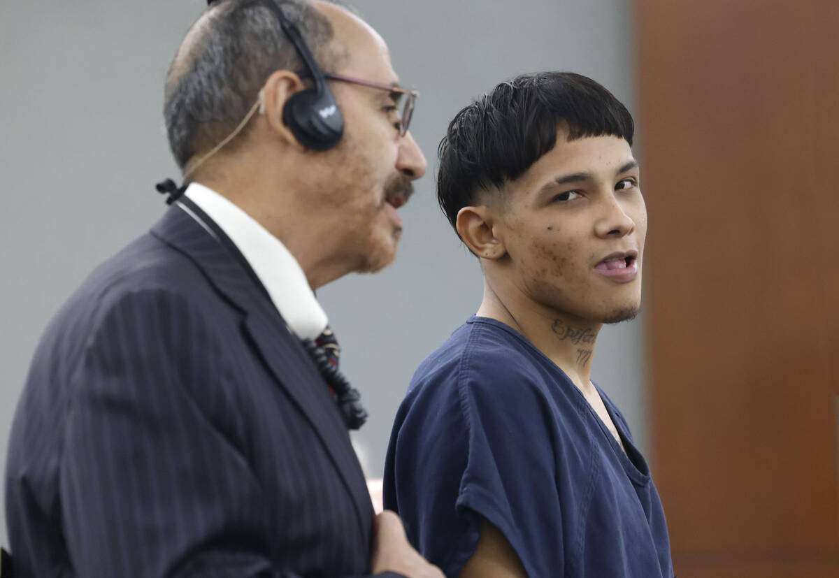 Delvison Escalona-Hernandez, right, a suspect in a fatal apartment stabbing, listens to an inte ...