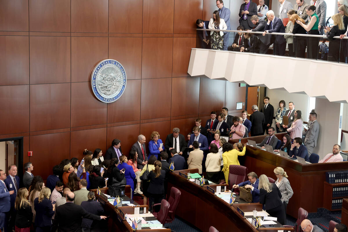 Members of the Senate Government Affairs Committee meet behind the bar during a recess in a Sen ...
