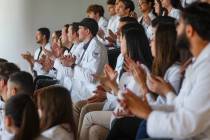 Students clap as Dr. Nehal S. Naik, out of frame, talks about the Nevada Healthcare Access Act ...