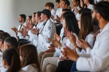 Students clap as Dr. Nehal S. Naik, out of frame, talks about the Nevada Healthcare Access Act ...