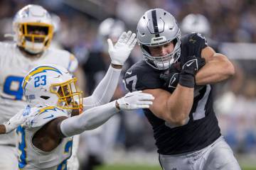 Los Angeles Chargers safety Tony Jefferson (23) tries to defend as Raiders tight end Michael Ma ...