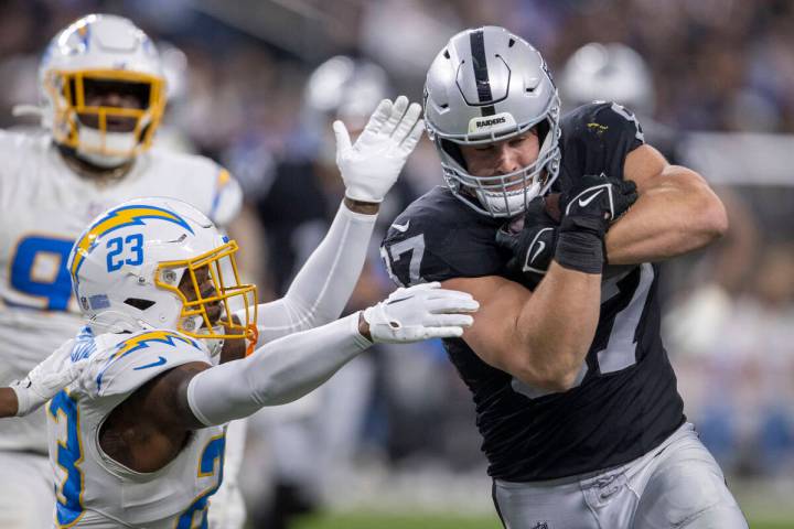 Los Angeles Chargers safety Tony Jefferson (23) tries to defend as Raiders tight end Michael Ma ...