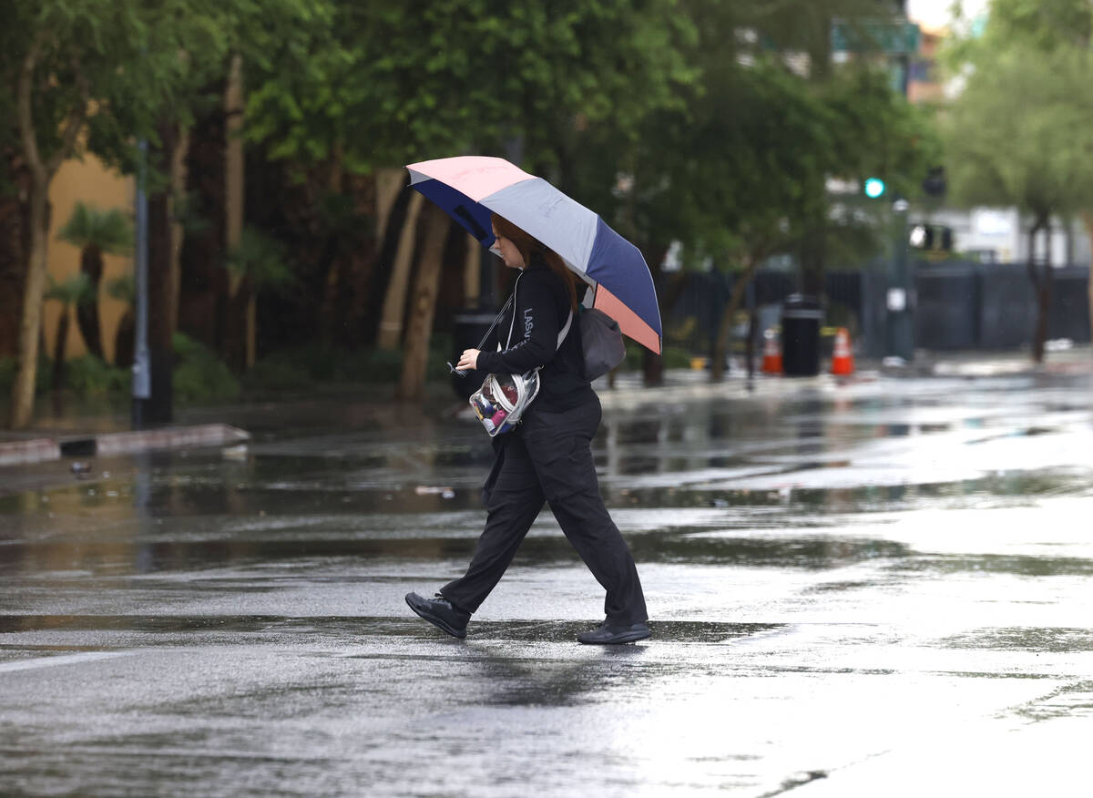 A pedestrian crosses Bridger Avenue during a rainy afternoon on Tuesday, June 3, 2025, in Las V ...