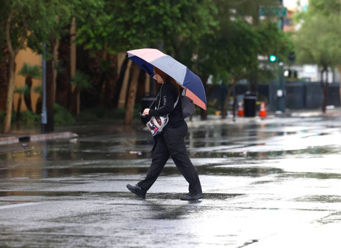 A pedestrian crosses Bridger Avenue during a rainy afternoon on Tuesday, June 3, 2025, in Las V ...