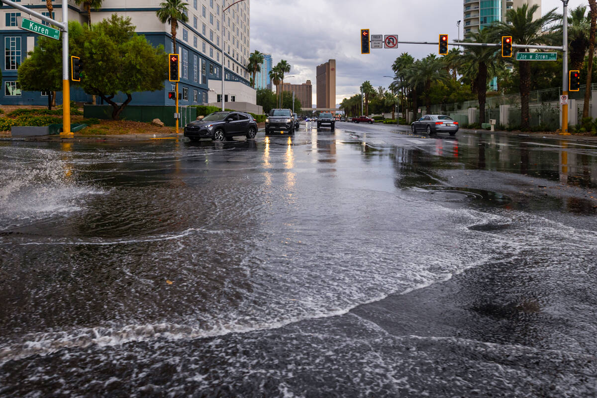Water fills part of the intersection at Joe W. Brown Drive and Karen Avenue as rain comes down ...