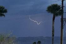 Lightning appears in the sky Monday, June 2, 2025, near Interstate 11 and North Durango Drive i ...