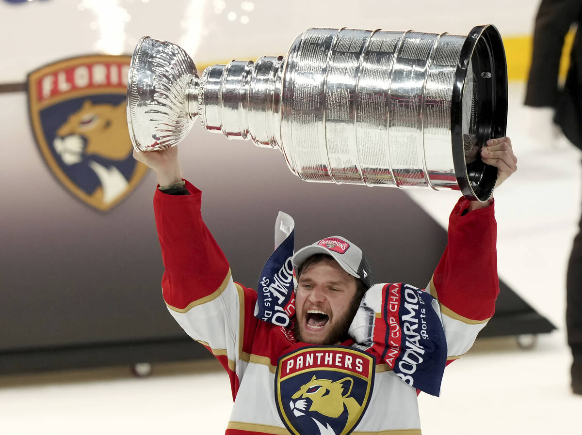 FILE - Florida Panthers forward Aleksander Barkov hoists the Stanley Cup after defeating the Ed ...