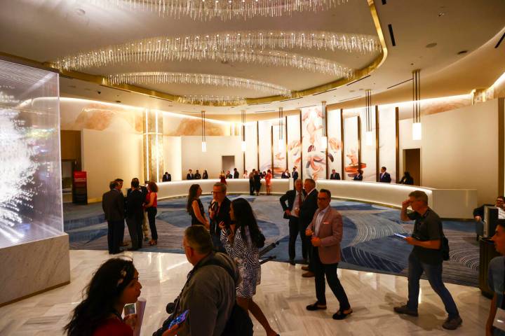 People walk through the Conrad hotel lobby during the opening night of Resorts World Las Vegas ...