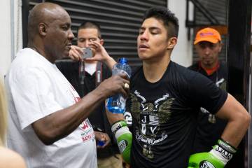 Boxing coach Mike McCallum, left, with Jessie Vargas during a media workout event at the Maywea ...