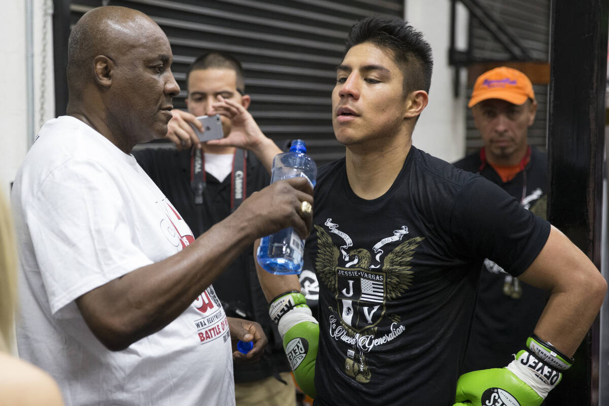 Boxing coach Mike McCallum, left, with Jessie Vargas during a media workout event at the Maywea ...