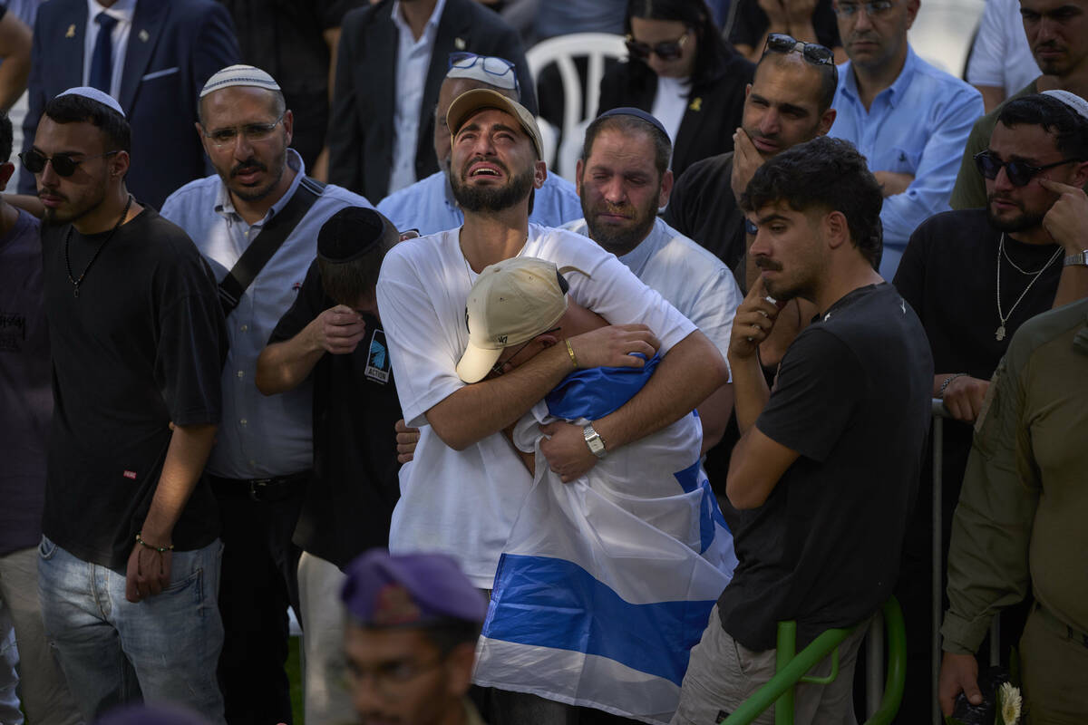 Mourners attend the funeral of Israeli soldier Sgt. Omer Van Gelder, who was killed in a battle ...